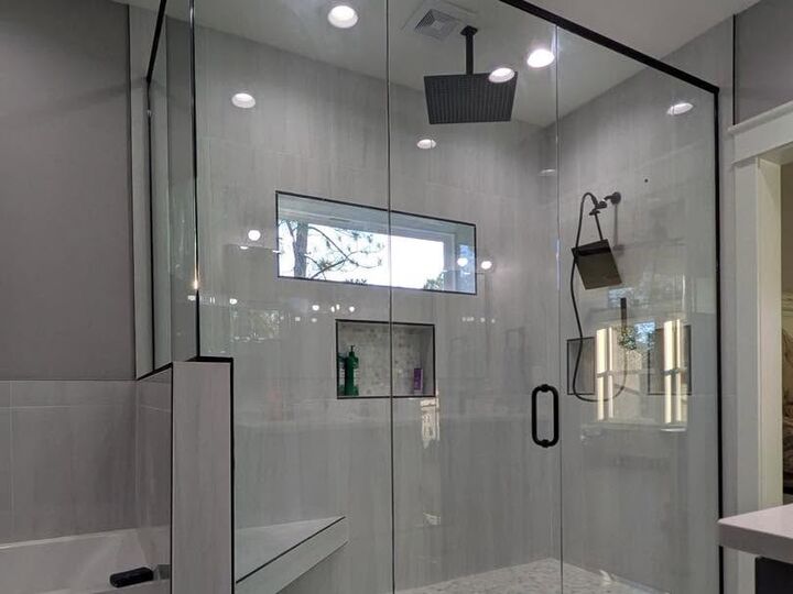 Frameless glass shower with matte black hardware