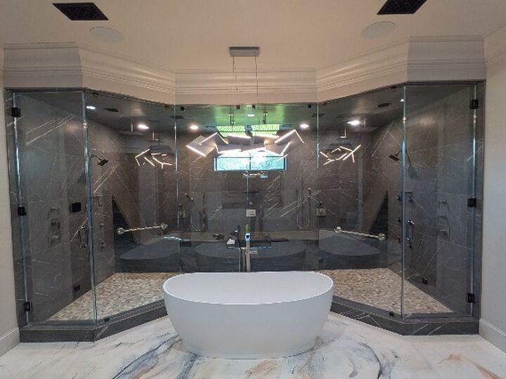 Large double custom shower enclosure with a freestanding tub
