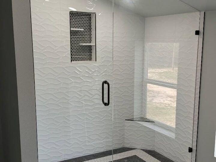Frameless sliding glass shower enclosure