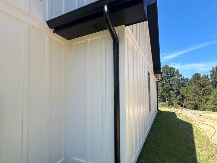 Seamless black gutter and downspout installation